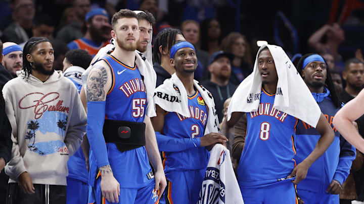 Feb 10, 2025; Oklahoma City, Oklahoma, USA; Oklahoma City Thunder guard Isaiah Joe (11), center Isaiah Hartenstein (55), forward Chet Holmgren (7), guard Shai Gilgeous-Alexander (2), forward Jalen Williams (8) and guard Luguentz Dort (5) watch the end of a game against the New Orleans Pelicans at Paycom Center. Mandatory Credit: Alonzo Adams-Imagn Images