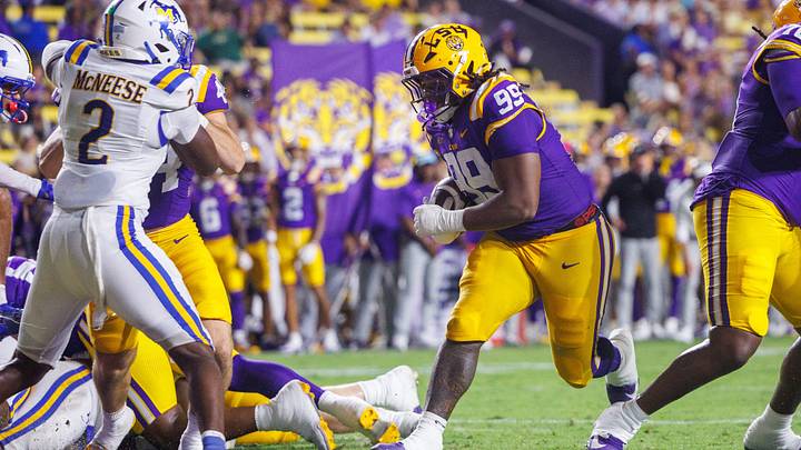 Oct 3, 2026; Baton Rouge, Louisiana, USA; LSU Tigers defensive tackle Deuce Geralds (99) rushes in for a touchdown against the McNeese Cowboys during the second half at Tiger Stadium. Mandatory Credit: Stephen Lew-Imagn Images Oct 3, 2026; Baton Rouge, Louisiana, USA; LSU Tigers defensive tackle Deuce Geralds (99) rushes in for a touchdown against the McNeese Cowboys during the second half at Tiger Stadium. Mandatory Credit: Stephen Lew-Imagn Images