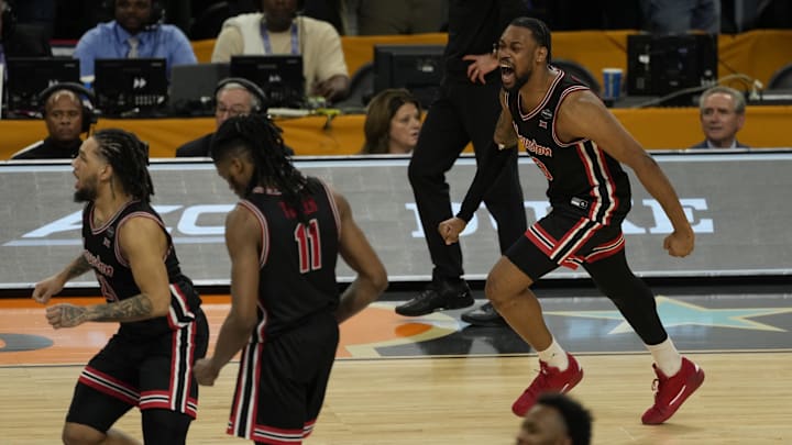 Houston players celebrate after knocking off Duke in the NCAA Tournament Final Four Saturday night. Houston players celebrate after knocking off Duke in the NCAA Tournament Final Four Saturday night.