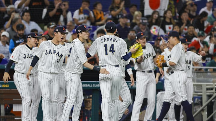 Mar 20, 2023; Miami, Florida, USA; Japan starting pitcher Roki Sasaki (14) celebrates with teammates after the first inning against Mexico at LoanDepot Park. Mar 20, 2023; Miami, Florida, USA; Japan starting pitcher Roki Sasaki (14) celebrates with teammates after the first inning against Mexico at LoanDepot Park.