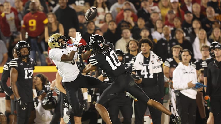 Oct 19, 2024; Ames, Iowa, USA; UCF Knights wide receiver Ja'Varrius Johnson (9) and Iowa State Cyclones defensive back Darien Porter (10) battle for a pass at Jack Trice Stadium