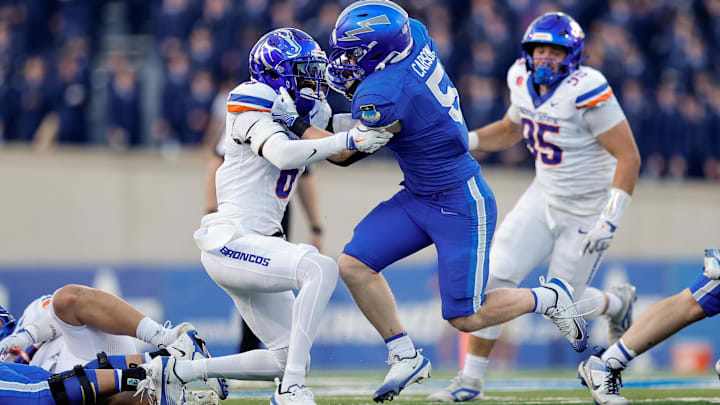 Air Force running back Dylan Carson is tackled by Boise State's Jeremiah Earby.