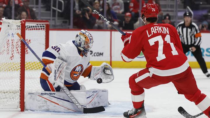 Feb 29, 2024; Detroit, Michigan, USA;  New York Islanders goaltender Ilya Sorokin (30) makes a save on Detroit Red Wings center Dylan Larkin (71) in the second period at Little Caesars Arena. Mandatory Credit: Rick Osentoski-Imagn Images