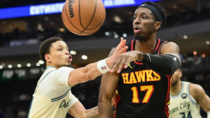 Mar 4, 2026; Milwaukee, Wisconsin, USA; Atlanta Hawks center Onyeka Okongwu (17) passes the ball away from Milwaukee Bucks guard Ryan Rollins (13) in the fourth quarter at Fiserv Forum. Mandatory Credit: Benny Sieu-Imagn Images