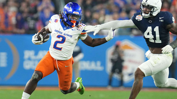 Boise State Broncos running back Ashton Jeanty runs past Penn State Nittany Lions linebacker Kobe King.