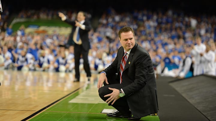 Kansas Jayhawks head coach Bill Self (right) and Kentucky Wildcats head coach John Calipari (background left) during the first half in the finals of the 2012 NCAA men's basketball Final Four at the Mercedes-Benz Superdome. 