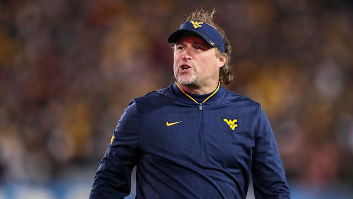 Nov 23, 2018; Morgantown, WV, USA; West Virginia Mountaineers head coach Dana Holgorsen yells along the sidelines during the second quarter against the Oklahoma Sooners at Mountaineer Field at Milan Puskar Stadium. Mandatory Credit: Ben Queen-Imagn Images Nov 23, 2018; Morgantown, WV, USA; West Virginia Mountaineers head coach Dana Holgorsen yells along the sidelines during the second quarter against the Oklahoma Sooners at Mountaineer Field at Milan Puskar Stadium. Mandatory Credit: Ben Queen-Imagn Images
