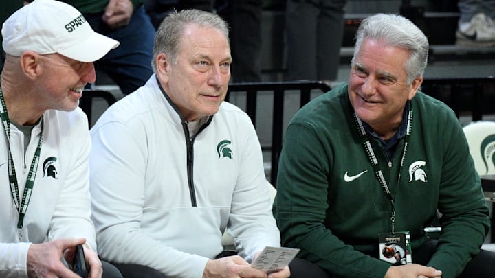 Feb 11, 2025; East Lansing, Michigan, USA;  Michigan State Spartans head coach Tom Izzo jokes with college pals Steve Mariucci and Jerry Rosburg (former NFL coach) at Jack Breslin Student Events Center. The pair attended the game hoping to see Izzo break Bobby Knight’s win record. Mandatory Credit: Dale Young-Imagn Images