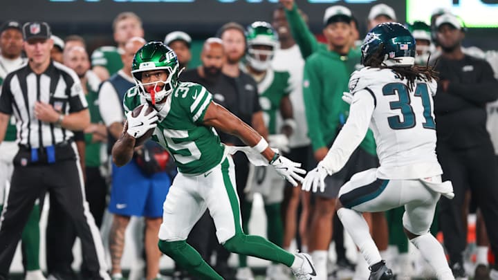 Aug 22, 2025; East Rutherford, New Jersey, USA; New York Jets wide receiver Dymere Miller (35) gains yards after catch as Philadelphia Eagles safety Andre' Sam (31) pursues during the second half at MetLife Stadium. Aug 22, 2025; East Rutherford, New Jersey, USA; New York Jets wide receiver Dymere Miller (35) gains yards after catch as Philadelphia Eagles safety Andre' Sam (31) pursues during the second half at MetLife Stadium.