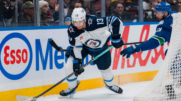 Mar 18, 2025; Vancouver, British Columbia, CAN; Vancouver Canucks defenseman Marcus Pettersson (29) defends against Winnipeg Jets forward Gabriel Vilardi (13) in the first period at Rogers Arena. Mandatory Credit: Bob Frid-Imagn Images
