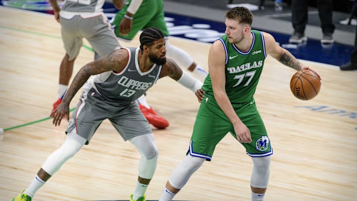 Mar 17, 2021; Dallas, Texas, USA; LA Clippers guard Paul George (13) and Dallas Mavericks guard Luka