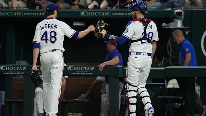 May 15, 2025; Arlington, Texas, USA; Texas Rangers pitcher Jacob deGrom (48) fist bumps catcher Jonah Heim (28) after pitching the seventh inning against the Houston Astros at Globe Life Field. Mandatory Credit: Raymond Carlin III-Imagn Images