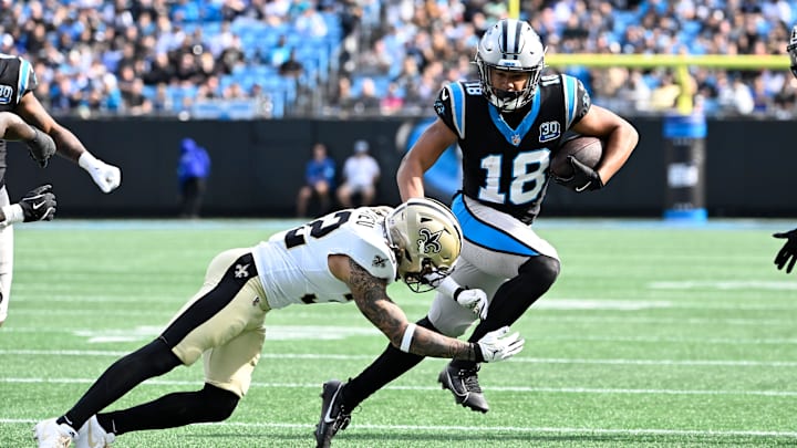 Nov 3, 2024; Charlotte, North Carolina, USA; Carolina Panthers wide receiver Jalen Coker (18) with the ball as New Orleans Saints safety Tyrann Mathieu (32) defends in the second quarter at Bank of America Stadium. Mandatory Credit: Bob Donnan-Imagn Images