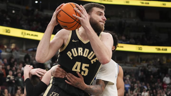 UCLA Bruins guard Skyy Clark (55) fouls Purdue Boilermakers center Oscar Cluff (45).