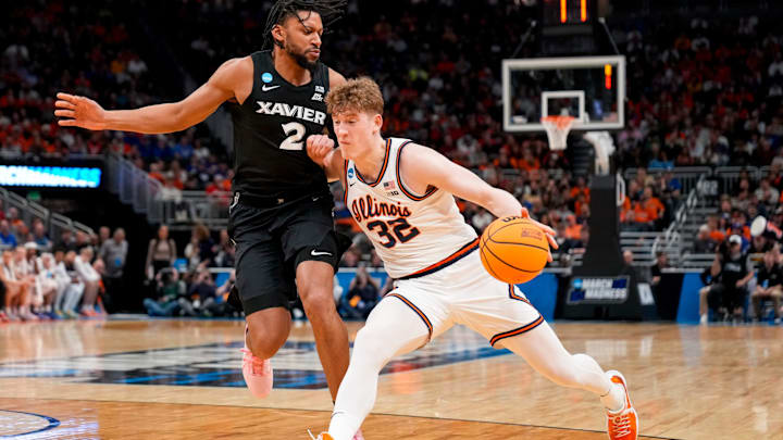 Illinois Fighting Illini guard Kasparas Jakucionis (32) drives against Xavier Musketeers forward Jerome Hunter (2) in the first half of the NCAA Tournament First Round game between the Illinois Fighting Illini and the Xavier Musketeers at Fiserv Forum in Milwaukee on Friday, March 21, 2025. Xavier was eliminated from the tournament, losing 86-73, to Illinois.