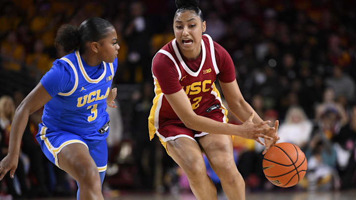 Feb 13, 2025; Los Angeles, California, USA;  USC Trojans guard JuJu Watkins (12) loses the ball against UCLA Bruins guard Londynn Jones (3) during the third quarter at Galen Center. Mandatory Credit: Robert Hanashiro-Imagn Images