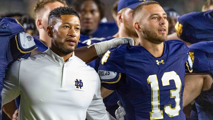 Sep 20, 2025; South Bend, Indiana, USA; Notre Dame Fighting Irish head coach Marcus Freeman and quarterback CJ Carr (13) sing the alma mater after beating the Purdue Boilermakers at Notre Dame Stadium. 