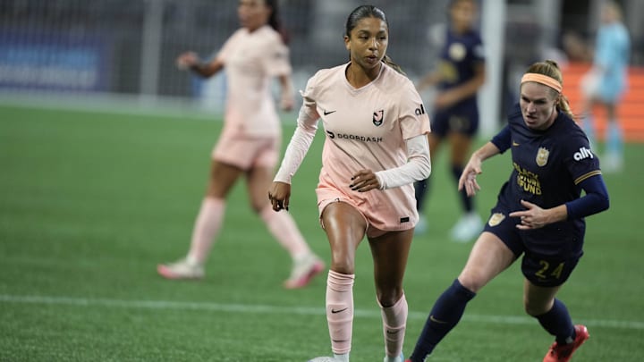 Angel City FC defender Madison Hammond (99) controls the ball against Seattle Reign FC forward Veronica Latsko (24) 