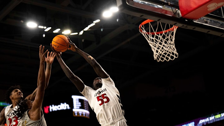 Cincinnati Bearcats forward Aziz Bandaogo (55) grabs a rebound over Alabama State Hornets guard Jalen Keago (10) in the first half of the NCAA basketball game at Fifth Third Arena in Cincinnati on Wednesday, Nov. 27, 2024. Cincinnati Bearcats forward Aziz Bandaogo (55) grabs a rebound over Alabama State Hornets guard Jalen Keago (10) in the first half of the NCAA basketball game at Fifth Third Arena in Cincinnati on Wednesday, Nov. 27, 2024.