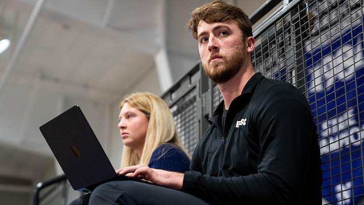 White Sox pitcher and Indianola Independent Advocate reporter Duncan Davitt watches as he covers a Norwalk girls basketball game on Nov. 24, 2025, at Norwalk High School.