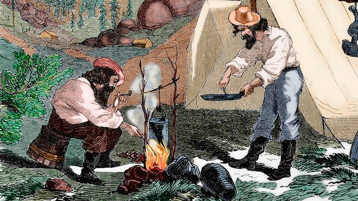Engraving of 19th century gold prospectors cooking at their camp by night (1857). Engraving of 19th century gold prospectors cooking at their camp by night (1857).