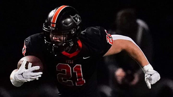 St. Xavier Tigers safety Adam Buehner (8) attempts to tackle Ryle Raiders running back Jacob Savage (21) in the first quarter of a high school football game between the Ryle Raiders and St. Xavier Tigers, Friday, Nov. 15, 2024, at Clifford R. Borland, Sr. Stadium in Union, Ky.
