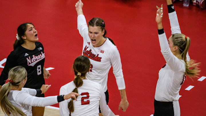 The Huskers celebrate Lindsay Krause's (middle) kill.