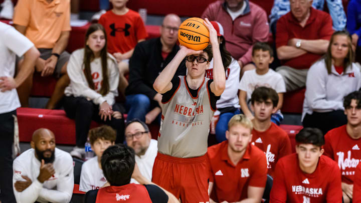 Rutgers transfer, Gavin Griffiths, shoots a three in front of Red team's bench. 