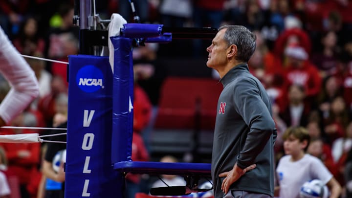Head Coach John Cook watches the Huskers' pre-game warmups. 