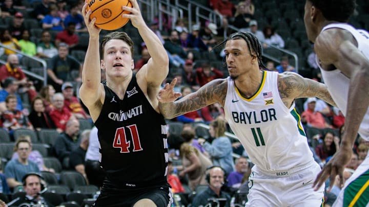 Mar 14, 2024; Kansas City, MO, USA; Cincinnati Bearcats guard Simas Lukosius (41) drives to the basket around Baylor Bears forward Jalen Bridges (11) during the second half at T-Mobile Center. Mandatory Credit: William Purnell-Imagn Images Mar 14, 2024; Kansas City, MO, USA; Cincinnati Bearcats guard Simas Lukosius (41) drives to the basket around Baylor Bears forward Jalen Bridges (11) during the second half at T-Mobile Center. Mandatory Credit: William Purnell-Imagn Images