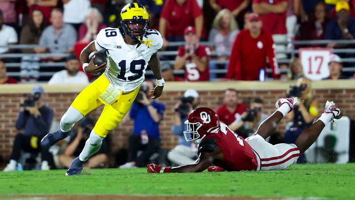 Michigan Wolverines quarterback Bryce Underwood runs past Oklahoma Sooners linebacker Sammy Omosigho