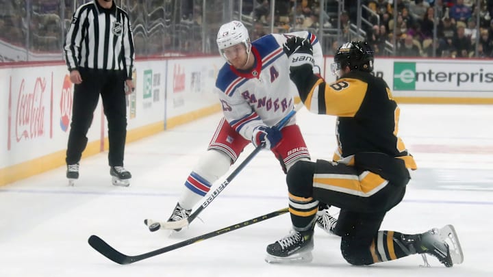 Alexis Lafreniere plays the puck against the Pittsburgh Penguins; Mandatory Credit: Charles LeClaire-Imagn Images