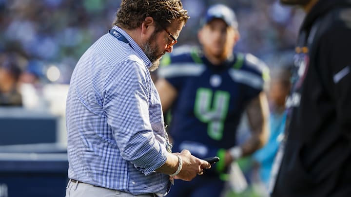 Oct 6, 2024; Seattle, Washington, USA; Seattle Seahawks general manager John Schneider looks at his phone during the fourth quarter against the New York Giants at Lumen Field. 
