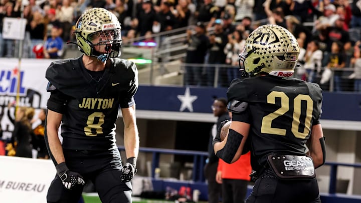 Griffith Reel (left) and Colt Gentry of Jayton celebrate a touchdown during the first half of Texas (UIL) 1A Six-Man D2 title game at AT&T Stadium.