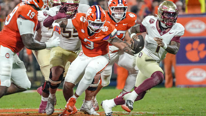 Nov 8, 2025; Clemson, South Carolina, USA; Florida State Seminoles quarterback Tommy Castellanos (1) runs near Clemson Tigers defensive end T.J. Parker (3) during the second quarter at Memorial Stadium. Mandatory Credit: Ken Ruinard - GREENVILLE NEWS-USA TODAY Network via Imagn Images Nov 8, 2025; Clemson, South Carolina, USA; Florida State Seminoles quarterback Tommy Castellanos (1) runs near Clemson Tigers defensive end T.J. Parker (3) during the second quarter at Memorial Stadium. Mandatory Credit: Ken Ruinard - GREENVILLE NEWS-USA TODAY Network via Imagn Images