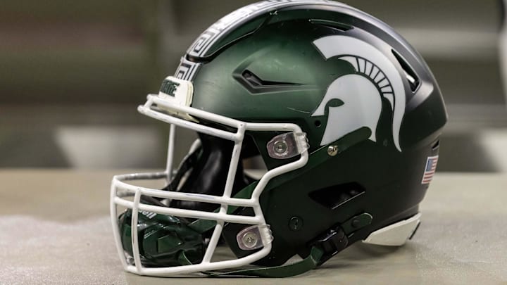 Nov 24, 2023; Detroit, Michigan, USA; A Michigan State Spartans helmet sits on a bench during the second half game against the Penn State Nittany Lions at Ford Field. Mandatory Credit: David Reginek-Imagn Images Nov 24, 2023; Detroit, Michigan, USA; A Michigan State Spartans helmet sits on a bench during the second half game against the Penn State Nittany Lions at Ford Field. Mandatory Credit: David Reginek-Imagn Images