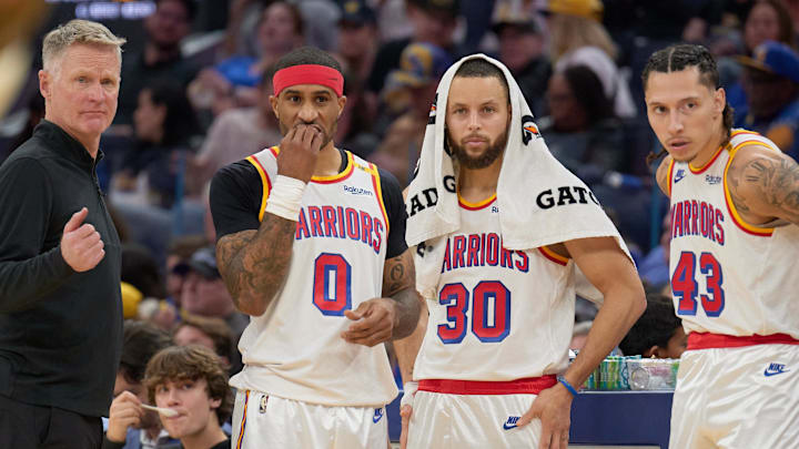 Jan 18, 2025; San Francisco, California, USA; Golden State Warriors head coach Steve Kerr, guard Gary Payton II (0), guard Stephen Curry (30) and forward Lindy Waters III (43) during a timeout against the Washington Wizards during the third quarter at Chase Center. Mandatory Credit: Robert Edwards-Imagn Images