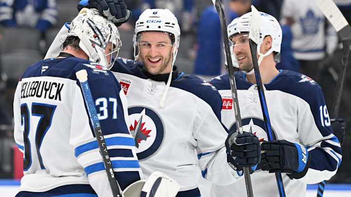 Dec 23, 2024; Toronto, Ontario, CAN;  Winnipeg Jets goalie Connor Hellebuyck (37) and defenseman Colin Miller (6) and forward David Gustafsson (19) celebrate a win over the Toronto Maple Leafs at Scotiabank Arena. Mandatory Credit: Dan Hamilton-Imagn Images