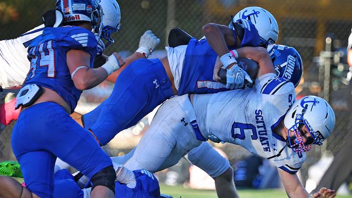 Scituate running back Grayson Foley stretches to get another few feet while being tackled by a few Quincy Presidents. The Quincy Presidents football team hosted the Scituate Sailors at Veterans Stadium on Friday, Oct. 9, 2026. Scituate running back Grayson Foley stretches to get another few feet while being tackled by a few Quincy Presidents. The Quincy Presidents football team hosted the Scituate Sailors at Veterans Stadium on Friday, Oct. 9, 2026.