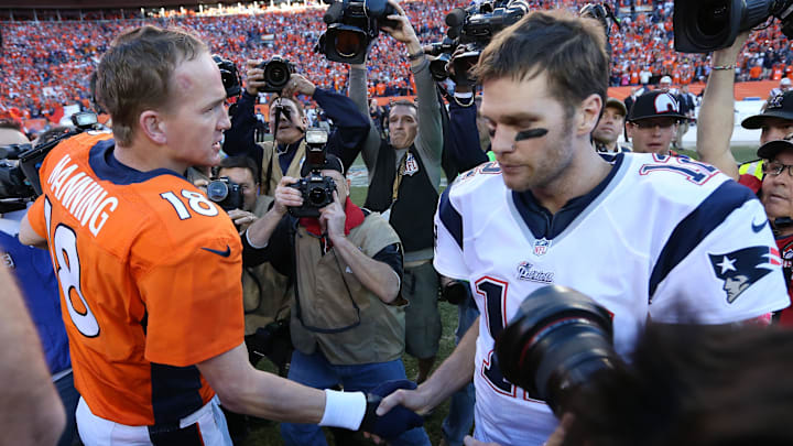 Denver Broncos quarterback Peyton Manning (18) meets with New England Patriots quarterback Tom Brady (12) after the 2013 AFC Championship game 