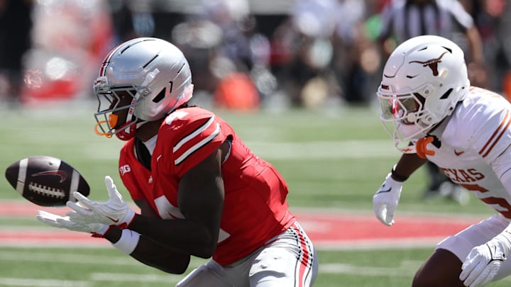 Aug 30, 2025; Columbus, Ohio, USA; Ohio State Buckeyes wide receiver Jeremiah Smith (4) makes a catch against Texas Longhorns defensive back Malik Muhammad (5) in the first half at Ohio Stadium. Mandatory Credit: Joseph Maiorana-Imagn Images