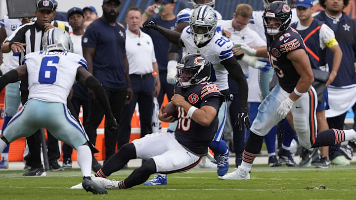 Caleb Williams hits the turf on a run in a win over Dallas.