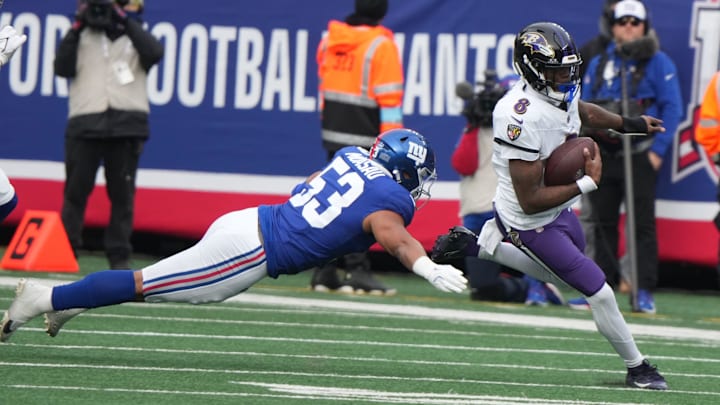 Darius Muasau of the Giants tries to tackle Lamar Jackson of the Ravens in the first half. The Baltimore Ravens came to MetLife Stadium to play the New York Giants.
