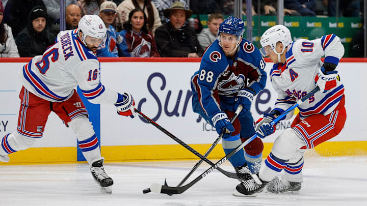 Nov 20, 2025; Denver, Colorado, USA; Colorado Avalanche center Martin Necas (88) battles for the puck with New York Rangers center Vincent Trocheck (16) and left wing Artemi Panarin (10) in the first period at Ball Arena. Mandatory Credit: Isaiah J. Downing-Imagn Images
