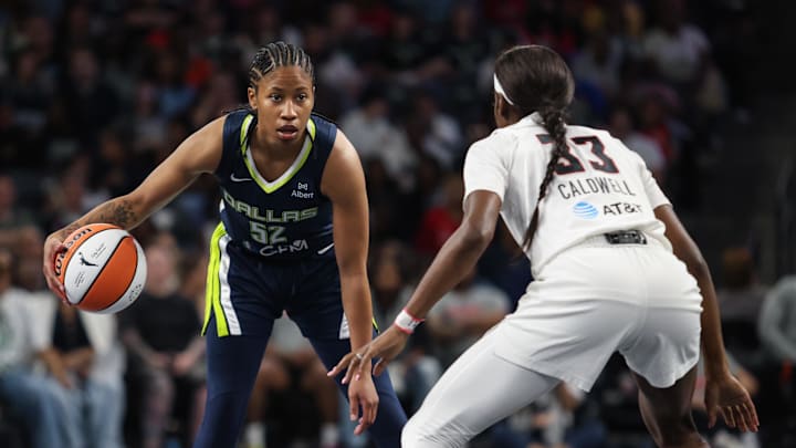 May 24, 2025; College Park, Georgia, USA; Atlanta Dream guard Maya Caldwell (33) plays defense against Dallas Wings guard Tyasha Harris (52) during the first quarter at Gateway Center Arena at College Park. Mandatory Credit: Jordan Godfree-Imagn Images