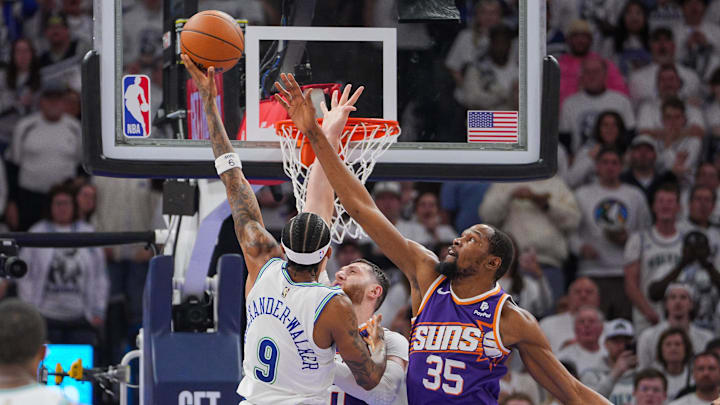 Apr 23, 2024; Minneapolis, Minnesota, USA; Minnesota Timberwolves guard Nickeil Alexander-Walker (9) shoots against Phoenix Suns forward Kevin Durant (35) in the second quarter during game two of the first round for the 2024 NBA playoffs at Target Center. Mandatory Credit: Brad Rempel-Imagn Images