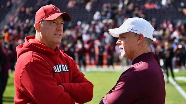 Blacksburg, Virginia, USA;  Virginia Tech Hokies coach Phillip Montgomery (left) and Louisville Cardinals head coach Jeff Brohm chat before the game at Lane Stadium.