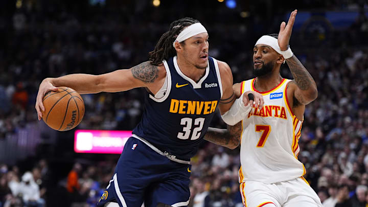 Jan 9, 2026; Denver, Colorado, USA; Atlanta Hawks guard Nickeil Alexander-Walker (7) defends on Denver Nuggets forward Aaron Gordon (32) in the second quarter at Ball Arena. Gordon may be the best player under any criteria to ever play in the Martin Luther King Classic presented by De La Salle. The 28th annual event takes place Monday at the Concord campus. Mandatory Credit: Ron Chenoy-Imagn Images