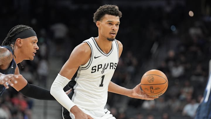 San Antonio Spurs center Victor Wembanyama (1) handles the ball in front of Orlando Magic forward Paolo Banchero (5) in the first half at Frost Bank Center. Mandatory Credit: Daniel Dunn-Imagn Images
