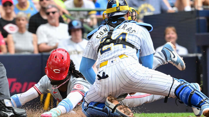 Jun 16, 2024; Milwaukee, Wisconsin, USA; Cincinnati Reds shortstop Elly De La Cruz (44) scores after an error before the tag by Milwaukee Brewers catcher William Contreras (24) in the third inning at American Family Field. Mandatory Credit: Benny Sieu-USA TODAY Sports